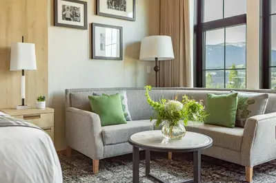 a living room with a couch and a table at Headwaters Lodge at Eagle Ranch Resort in Invermere