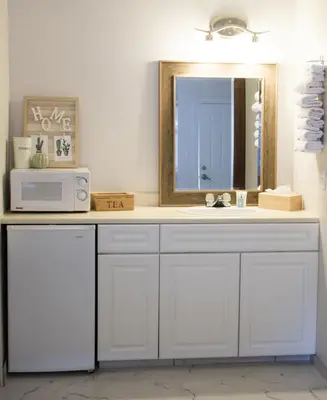 a bathroom with a sink and a mirror at Christina Lake Motel and RV Park in Christina Lake