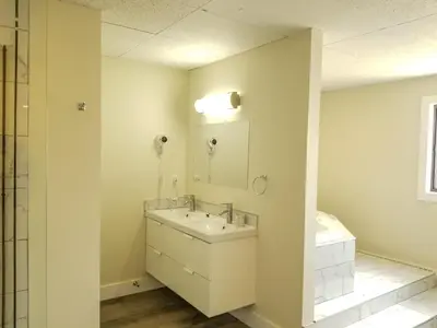 a bathroom with a sink and a mirror at 7 Day's Hotel in Lamont