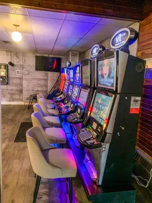 a row of video game machines in a room at 7 Day's Hotel in Lamont