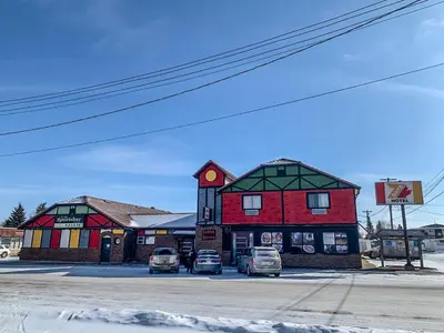 a couple of buildings with cars parked in front of them at 7 Day's Hotel in Lamont