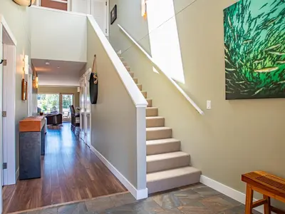 a staircase in a home with a painting on the wall at The Moorage in Ucluelet