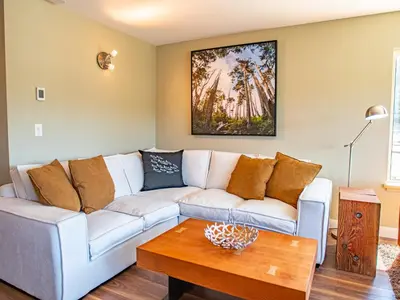 a living room with a couch and a table at The Moorage in Ucluelet