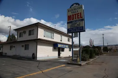a motel sign sitting in front of a building at Ranchland Villa Motel in Merritt