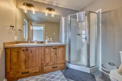 a bathroom with two sinks and a shower at Echo Landing#02 By Bear Country in Sun Peaks