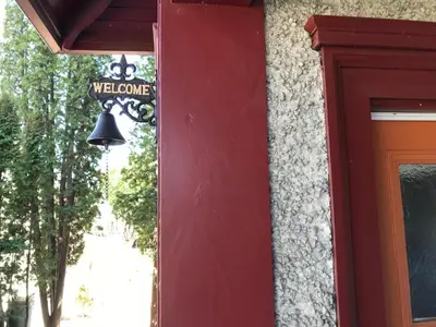 a bell hanging on the side of a building at Stirling House in Kelowna