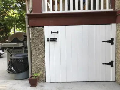 a garage with white doors on a house at Stirling House in Kelowna