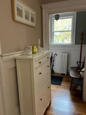 a white dresser in a room with a window at Stirling House in Kelowna