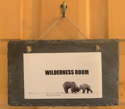 a sign that says wilderness room with two bears at Ambleside Lodge Bed & Breakfast in Canmore
