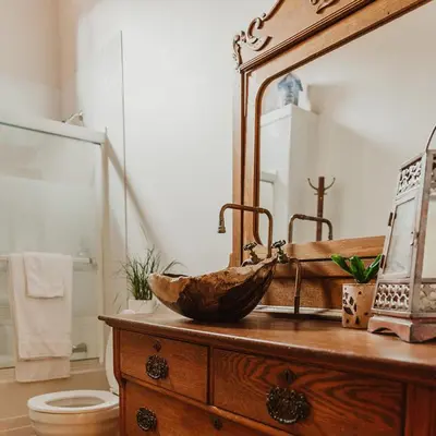 a bathroom with a wooden sink and a mirror at Ambleside Lodge Bed & Breakfast in Canmore