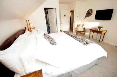 a bedroom with two white beds in a room at North House - Banff Mountain Home- The Real Rockies Experience in Banff
