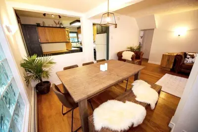 a dining room with a wooden table and chairs at North House - Banff Mountain Home- The Real Rockies Experience in Banff
