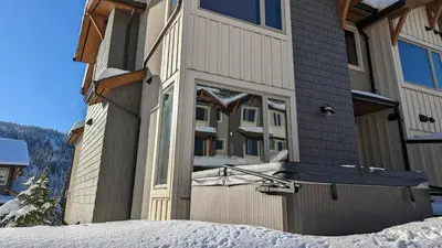 a large house with a snow covered front door at Echo Landing #12 by Bear Country in Sun Peaks