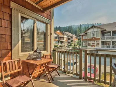 a balcony with a table and chairs and a window at Settlers Crossing #70 by Bear Country in Sun Peaks