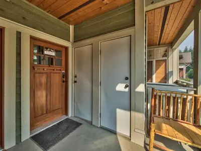a front door of a house with a wooden ceiling at Settlers Crossing #70 by Bear Country in Sun Peaks