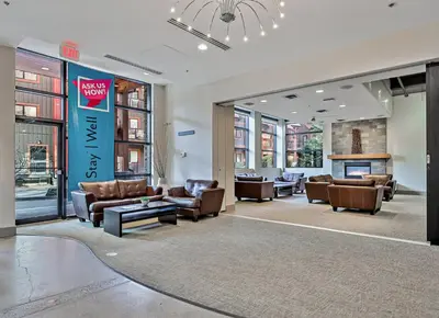 a lobby with couches and chairs in a building at Sophisticated MTN 2 Bedroom Pool Hot Tub managed by Little Sister Getaways in Canmore