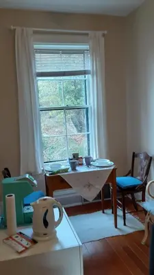 a living room with a table and a window at Sea Birds Cottage in Victoria