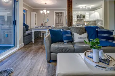 a living room with blue and white pillows on a couch at Sunpath Retreat- Convenience Meets Comfort & Style in Whistler