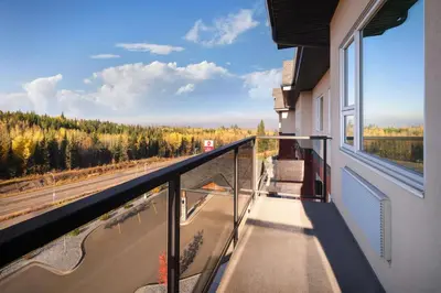 a balcony with a view of a road and trees at Best Western Plus Prince George in Prince George