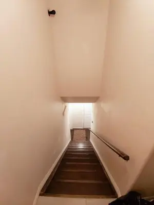 a stairway leading up to a room with a white wall at Parson Creek Retreat in Fort McMurray