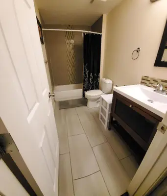 a bathroom with a toilet and a sink at Parson Creek Retreat in Fort McMurray