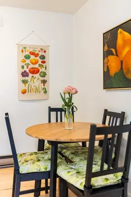a dining room table with chairs and a vase of flowers at The Wayward Inn in Chemainus