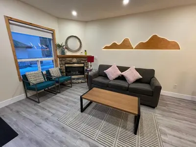 a living room with a couch and a table at Banff Woods lodge in Canmore