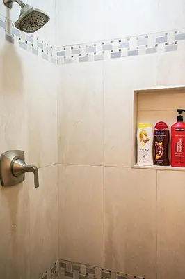 a bathroom with a shower with soap and toiletries at Banff Woods lodge in Canmore