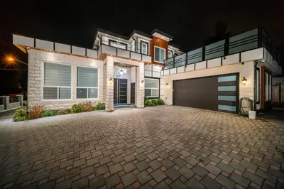 a large house with a garage at night at Sun suite in Surrey