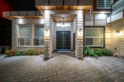 a house with a black door and a brick driveway at Sun suite in Surrey