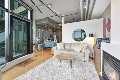 a living room with a couch and a table at Harbourview Executive Condo by EMR Vacation Rentals in Victoria