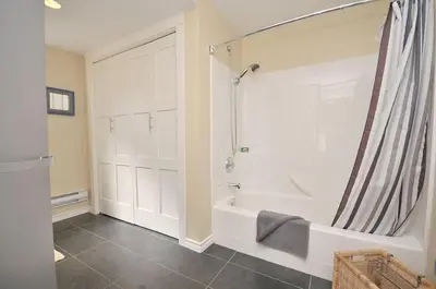 a bathroom with a shower and a bath tub at Heron View Cottage by EMR Vacation Rentals in Sidney