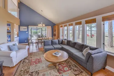 a living room with a couch and a table at Kye Bay Beach House by EMR Vacation Rentals in Comox
