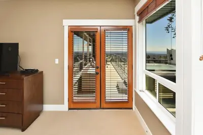 a room with a door with a view of a balcony at Nature's Gate Executive Estate by EMR Vacation Rentals in Victoria
