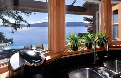 a kitchen with a window with a view of the water at Oceanside Lodge Saanich Inlet by EMR Vacation Rentals in North Saanich