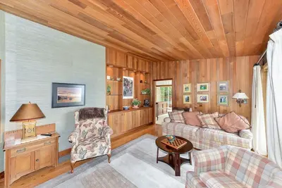 a living room with a couch and a table at Oceanside Lodge Saanich Inlet by EMR Vacation Rentals in North Saanich