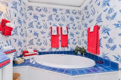 a bathroom with a tub and blue and red towels at Oceanside Lodge Saanich Inlet by EMR Vacation Rentals in North Saanich