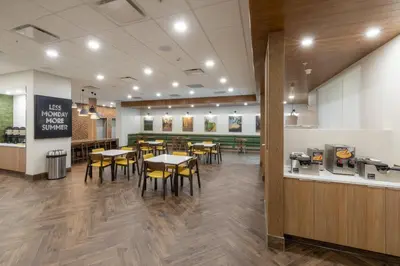 a dining area with tables and chairs in a restaurant at Fairfield Inn & Suites by Marriott Salmon Arm in Salmon Arm