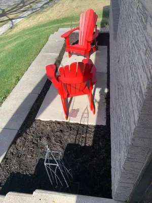 two red chairs are sitting on a patio at Studio on Capri in Calgary
