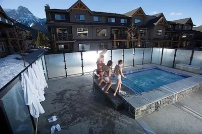 a group of children standing around a swimming pool at Copperstone Resort in Dead Man's Flats