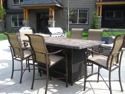 a patio table with chairs and a grill at Copperstone Resort in Dead Man's Flats