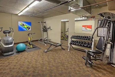 a gym with tread machines and exercise equipment in a room at Copperstone Resort in Dead Man's Flats