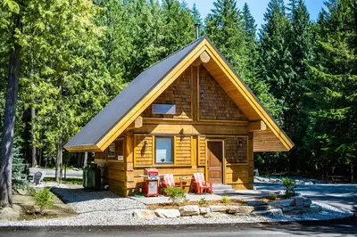 a small log cabin with a pitched roof at Boulder Mountain Resort in Revelstoke
