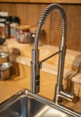 a kitchen sink with a chrome kitchen faucet at Boulder Mountain Resort in Revelstoke