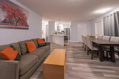 a living room with a couch and a dining room at Luxurious One Bedroom Suite for a Larger Family 162 in Canmore