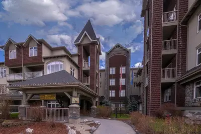 a large apartment building with a gazebo at Luxurious One Bedroom Suite for a Larger Family 162 in Canmore