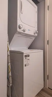 a microwave above a refrigerator in a kitchen at Luxurious One Bedroom Suite for a Larger Family 162 in Canmore