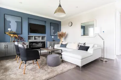 a living room with a white couch and a table at 5-Star Luxury and comfortable home in New Westminster