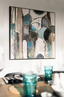 a painting hanging on a wall above a table at 5-Star Luxury and comfortable home in New Westminster