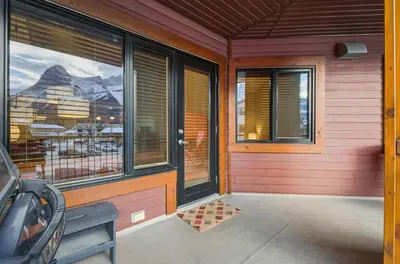 a front door of a house with a view of a mountain at Beautiful Peak Vista - 2BR w Stunning Mt Views in Canmore